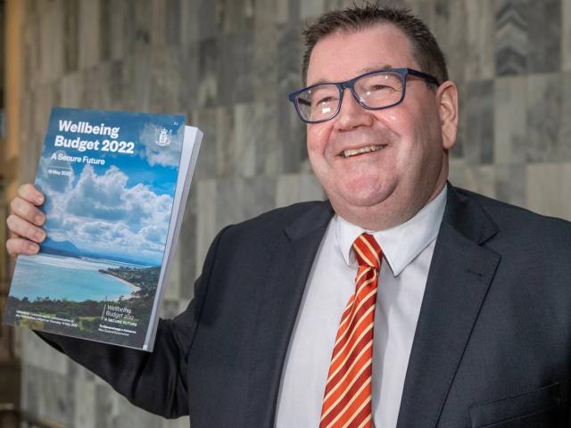 Finance Minister Grant Robertson with a copy of his Wellbeing Budget 2022 at Parliament. Photo:...