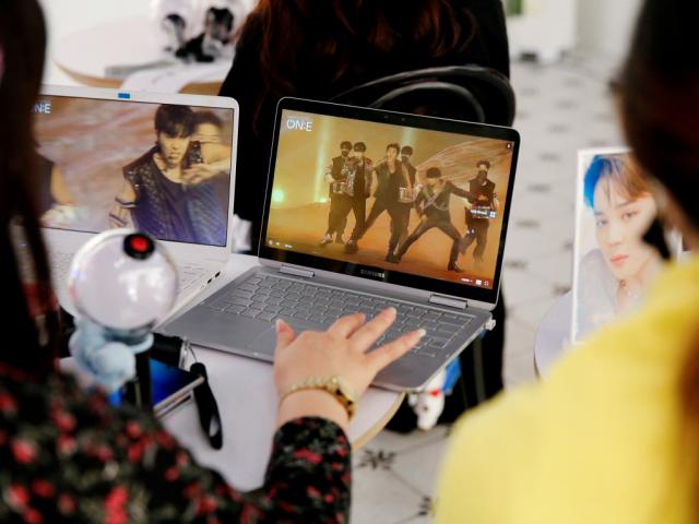 Fans of K-pop band BTS watch a live streaming online concert at a cafe in Seoul. File photo: Reuters