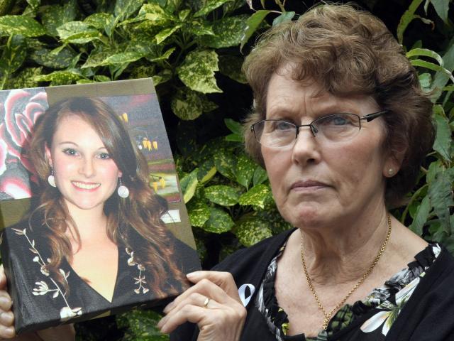 Lesley Elliott holds a photograph of her daughter Sophie, who was murdered in 2008. Mrs Elliott...