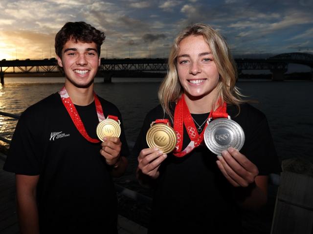 Winter Olympic gold medallists Nico Porteous and Zoi Sadowski-Synnott beam with joy after their...