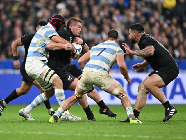 All Black Ethan de Groot (with ball) is tackled by Matias Alemanno of Argentina during the Rugby...