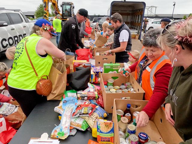Volunteers sorted through more than 135 boxes of food. Photo: Geoff Sloan
