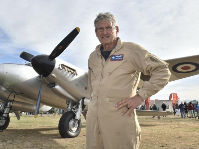 Pilot Steve Hinton, of the United States, stands in front of a newly restored Mosquito de...