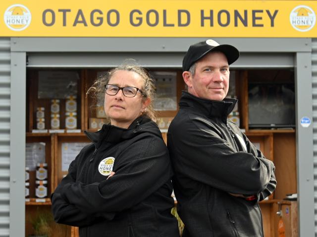 Otago Gold Honey owners Carlee McCaw and Tom Sinclair stand in front of their honey stall...