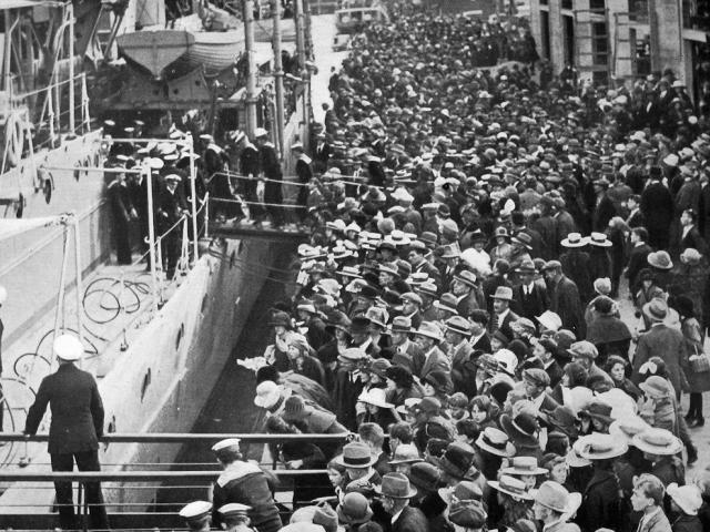 A crowd on the Rattray St wharf following the berthing of British light cruiser HMS Dunedin, soon...