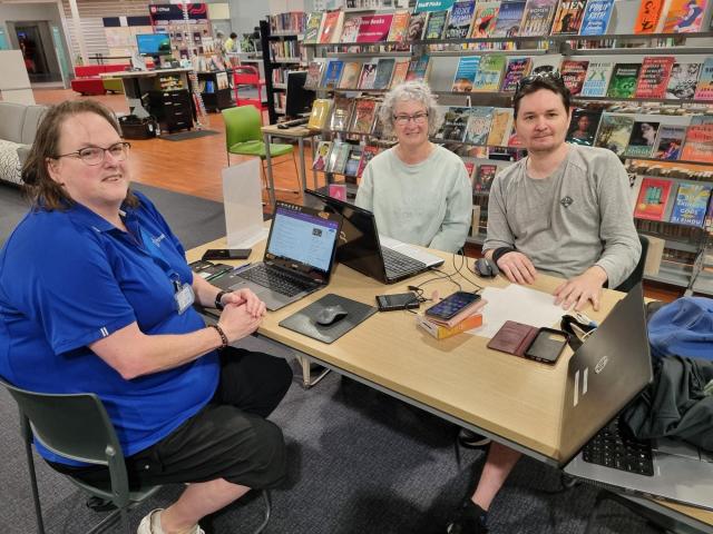 TechMate volunteers help resident with her laptop at Linwood library. PHOTO: SUPPLIED