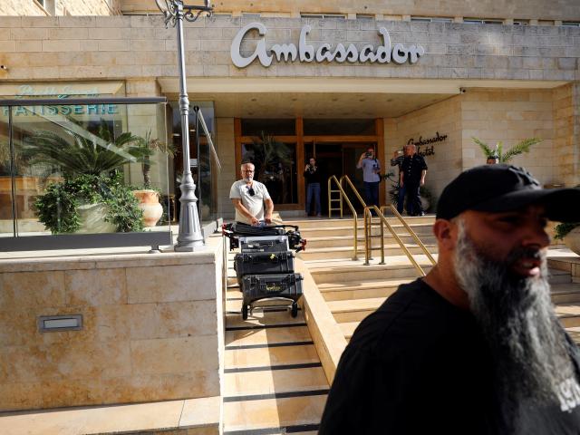 A man removes media equipment following an Israeli police raid on an Al Jazeera de facto office...
