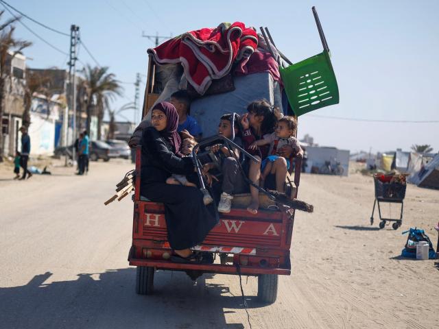 Palestinians flee Rafah after Israeli forces launched a ground and air operation in the eastern...