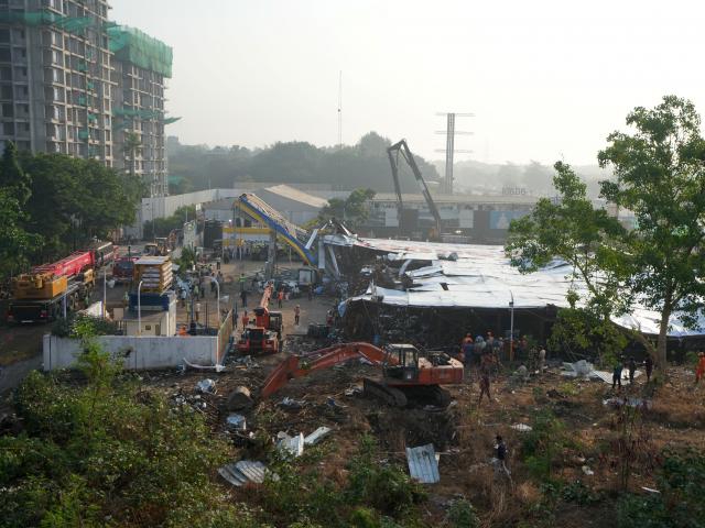 Rescue teams search for survivors after a massive billboard fell during a rainstorm in Mumbai....
