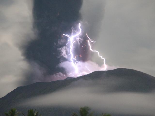 Lightning appears amid a storm as Mount Ibu spews volcanic material during the eruption. Photo:...