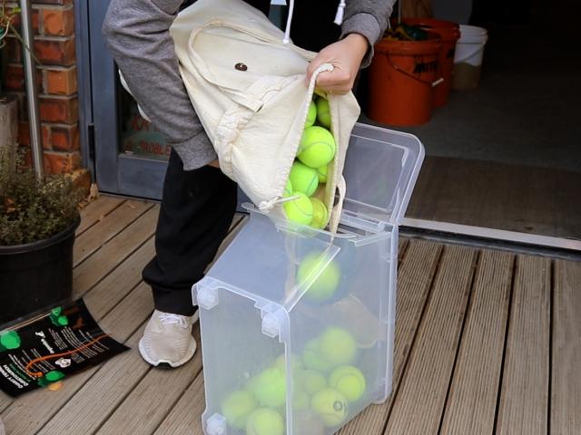 Lena Tiebosch filling the box up with tennis balls from Edgeware Tennis Club. Photo: Emily O'Hagan