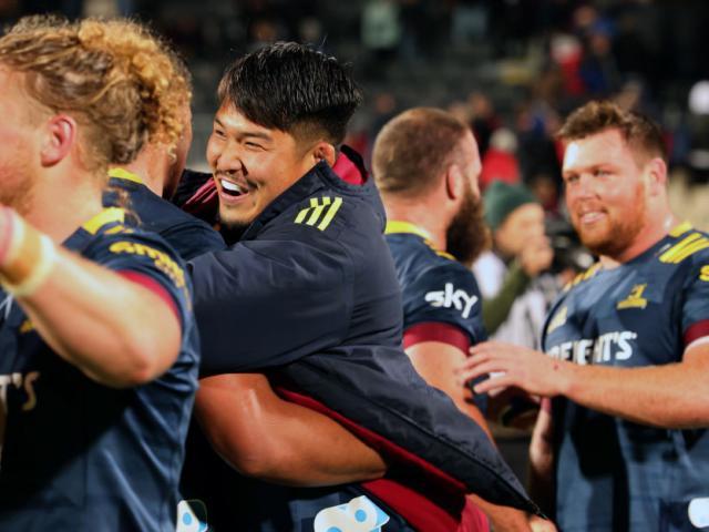 Highlanders loose forward Kazuki Himeno hugs team-mates after the win over the Crusaders in...