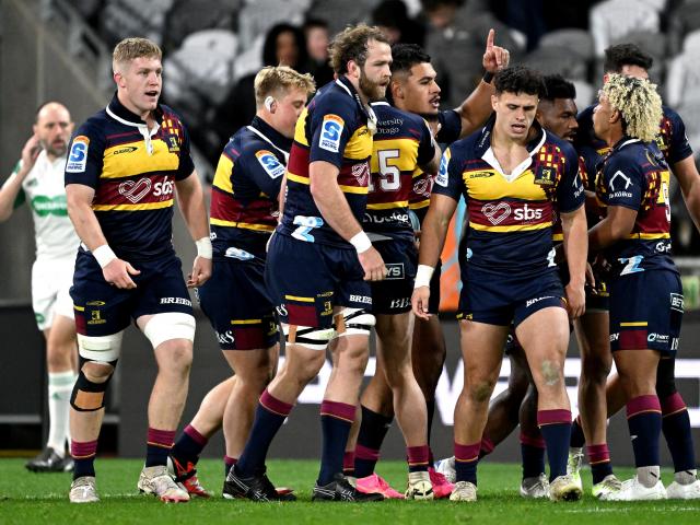 The Highlanders celebrate after midfielder Tanielu Tele’a scored the opening try against the...