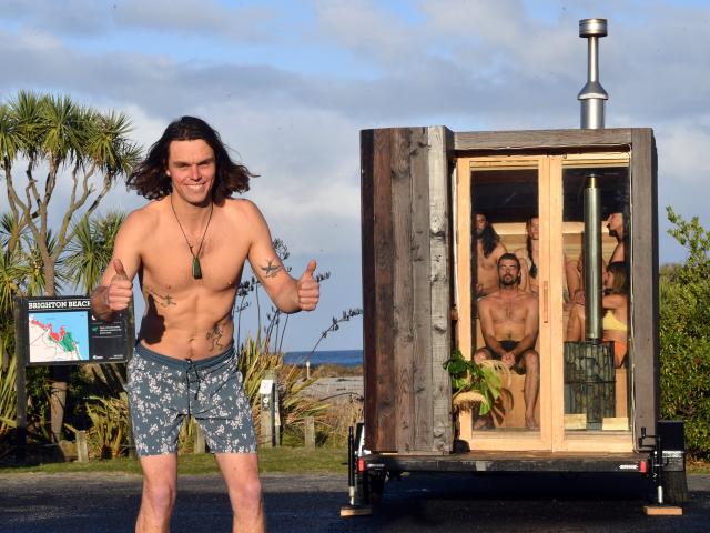 Oranga Saunas founder Josiah Lilburne tries out his portable sauna at Brighton Beach. PHOTO:...