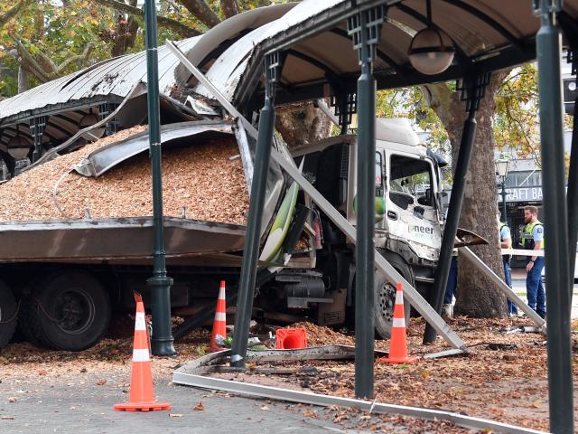 The destroyed Pioneer Energy truck which crashed through the Octagon in Dunedin, with police and...