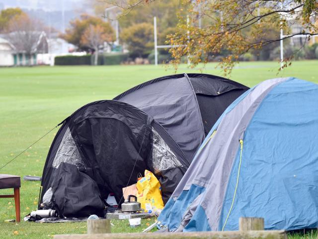 A homeless woman in a tent at the Oval walks with a crutch, yet has been waiting for a state home...