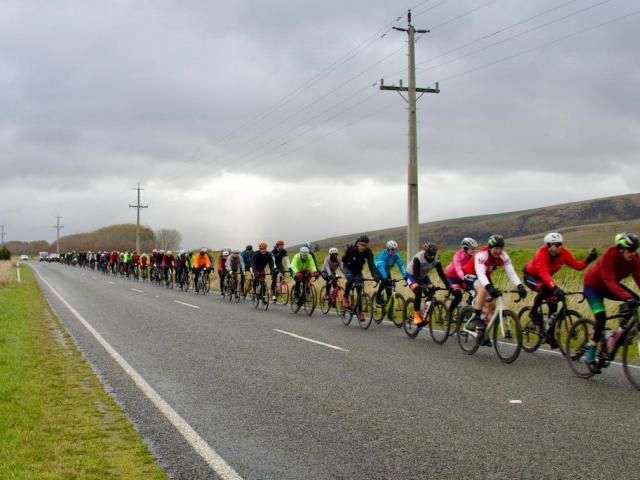 Cyclists head through frozen and green hills on the way from Queenstown to Invercargill. PHOTO:...