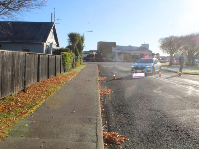 Police near the scene in Invercargill on Sunday morning. Photo: Nina Tapu
