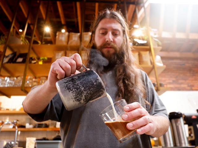 Alex Sciarrotta, owner of Narrative Coffee, makes a 6-ounce espresso and milk coffee drink in...