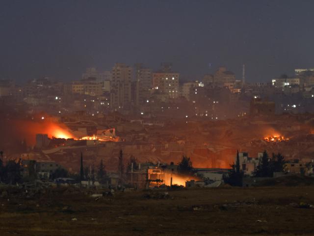 Flames rise from northern Gaza, as seen from the Israeli side of the Israel-Gaza border, on...