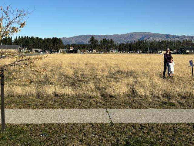 Lisa Riley and her son on the site of the proposed Super Liquor store.  Photo: Supplied/Lisa Riley