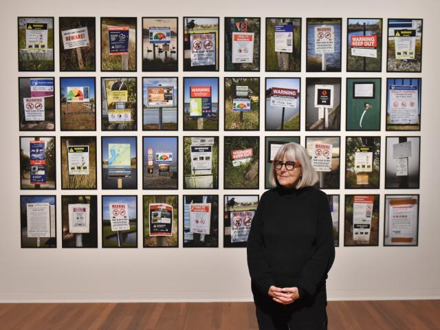 Photographer Anne Noble drives the message home with her warning sign wall in ‘‘Unutai e! Unutai...