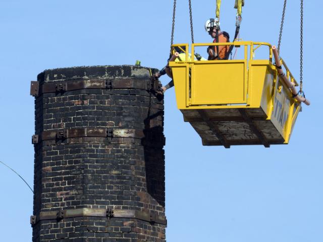 Contractors take measurements at the top of the Dunedin Gasworks chimney. Photo: Gerard O'Brien
