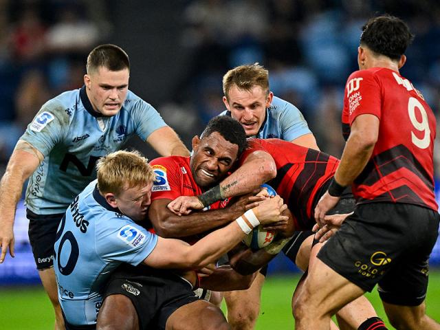 Crusaders wing Sevu Reece is tackled by Hugh Sinclair of the Waratahs. Reece went on to score a...