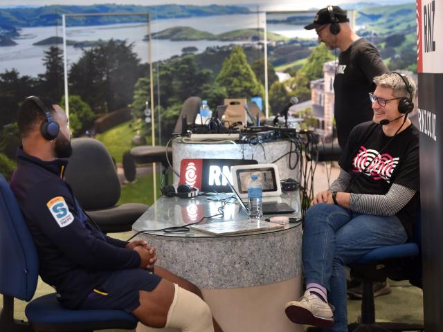 RNZ presenter Jesse Mulligan (right) talks to Highlander Jona Nareki at the isite visitor centre...