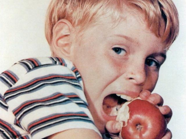Jay North, US actor, biting into an apple in a portrait issued as publicity for the US television...