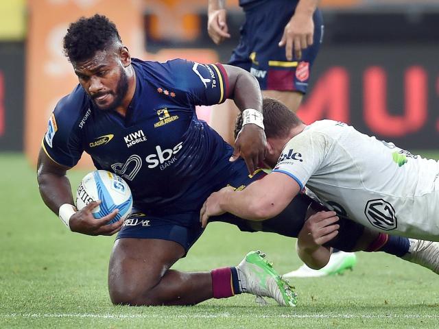 Highlanders midfielder Timoci Tavatavanawai is tackled by Blues flanker Dalton Papali’i during...