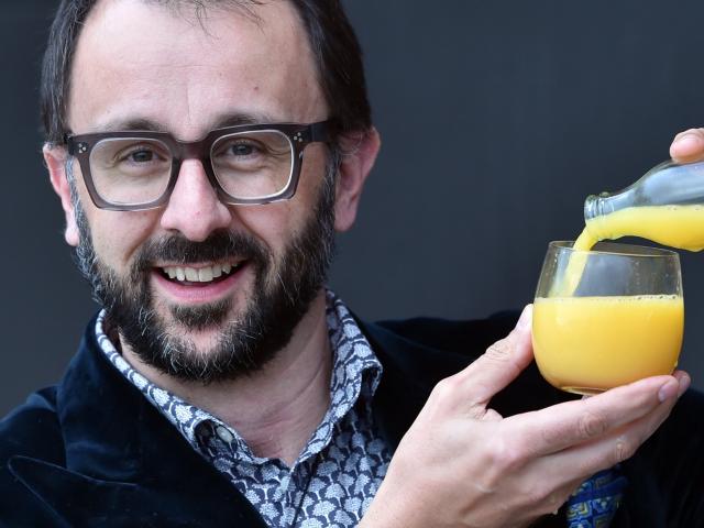 Dunedin oncologist Prof Chris Jackson pours a glass of orange juice, referencing a vitamin C ...