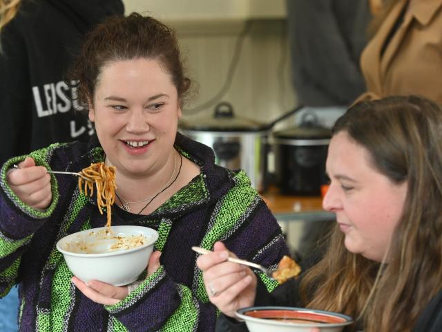 Tia Taita (left) and her friend Shannon van Rooijen enjoy a meal at the North East Valley Project...