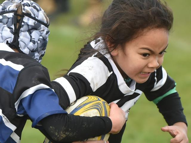 Southern player Utalia Moataane, 6, charges on at the annual Taieri sevens junior rugby...
