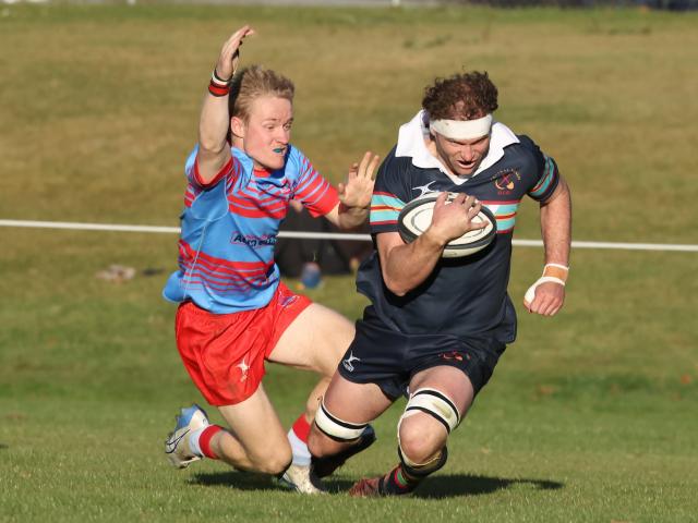 Central Otago lock Dean Sinnamon beats South Otago defender Sam Stratford to score a try during...