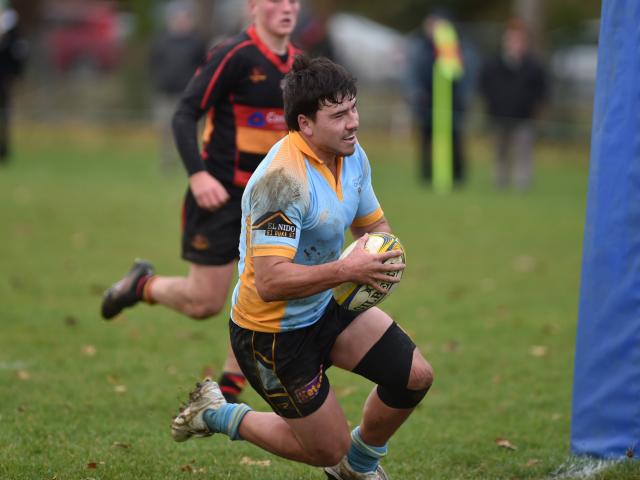 University second five Mac Harris dives over for a try against Zingari-Richmond during a Dunedin...
