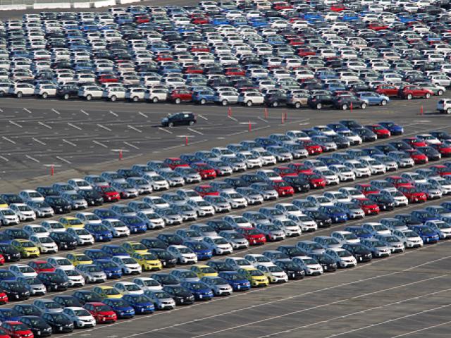 Hundreds of imported cars that arrived by ship are lined up in rows at the Port of Richmond, San...