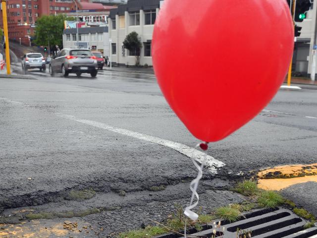 A red balloon strung up above a MacLaggan St gutter. PHOTO: STEPHEN JAQUIERY.