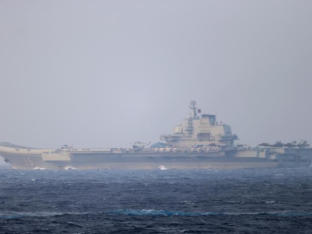 Chinese aircraft carrier Liaoning sails through the Miyako Strait near Okinawa on its way to the...
