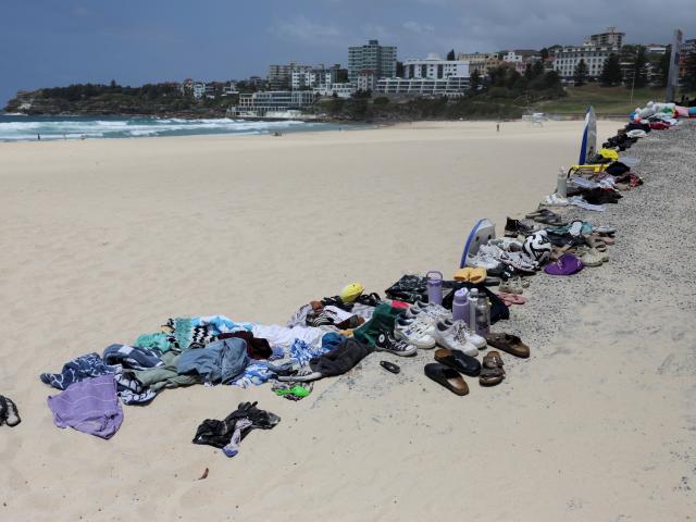 Belongings left behind by people are gathered at the beach near the scene of a shooting during a...