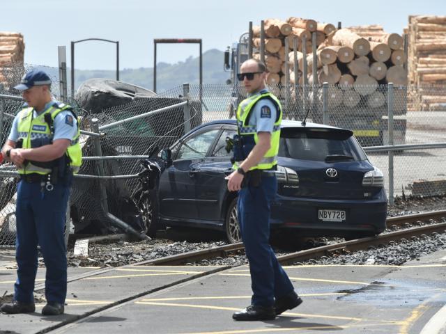 Police officers at the scene of the crash in Beach St, Port Chalmers. Photo: Gregor Richardson