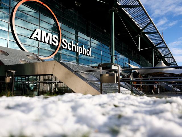 Snow lies outside Amsterdam's Schiphol Airport as a wintry blast continues to cause disruptions...