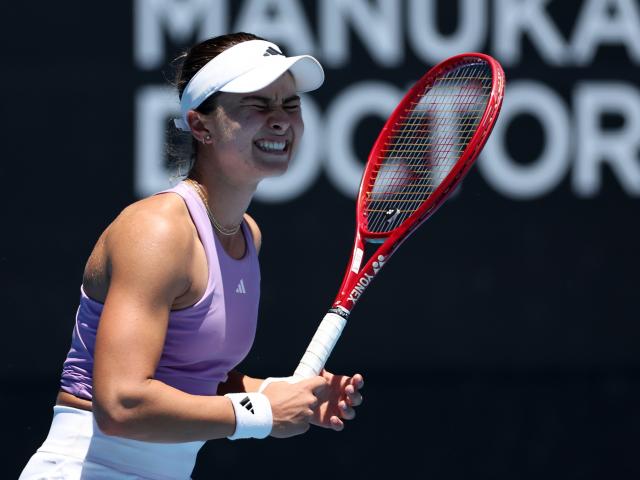 Iva Jovic, of the United States, grimaces as she loses a point during her match against Czech...