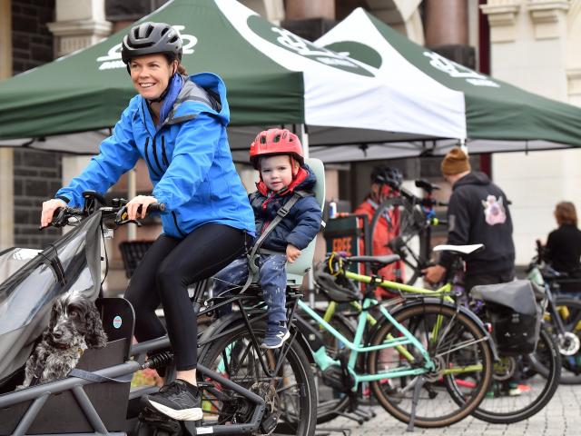 Refreshed following a free fuel-up, Emily Cambridge with son Henry (2) and Artie their dog leave...