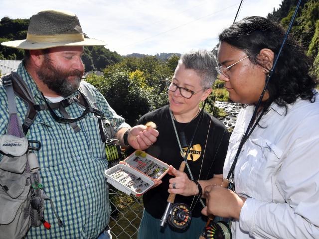 Otago Anglers Association president Mark Barrett shows a rabbit tail streamer fly to Carrie...