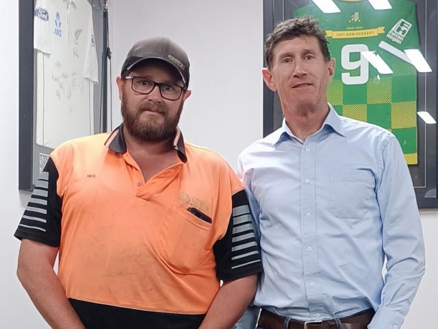 Neil Cockburn (left) receives a health and safety award from Wenita Forest Products chief...