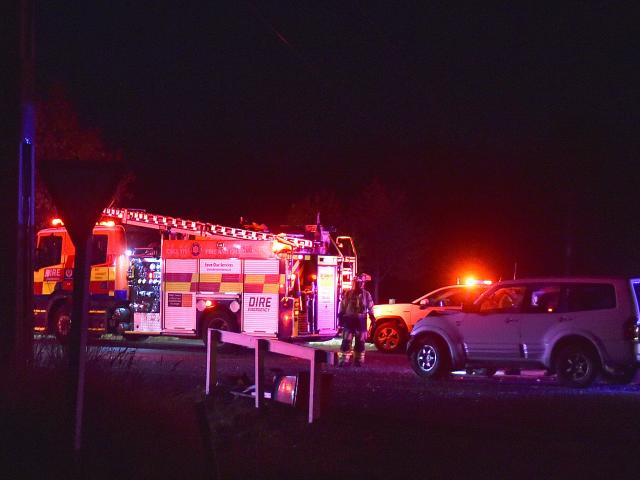 Emergency staff at the scene on Friday night. PHOTO: PETER MCINTOSH