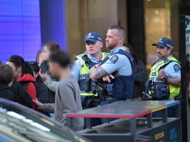 Police keep an eye on the group in George St this afternoon. PHOTO: GERARD O'BRIEN