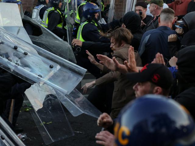 Protesters clash with police officers during a demonstration in Southampton following the...