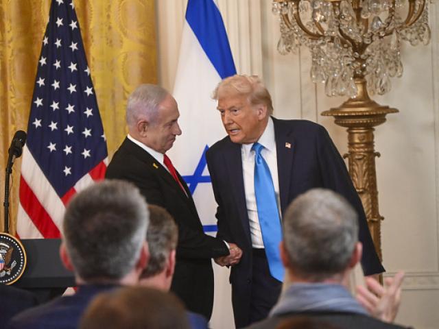Israeli Prime Minister Benjamin Netanyahu (L) and US President Donald Trump (R) and (L) shake...
